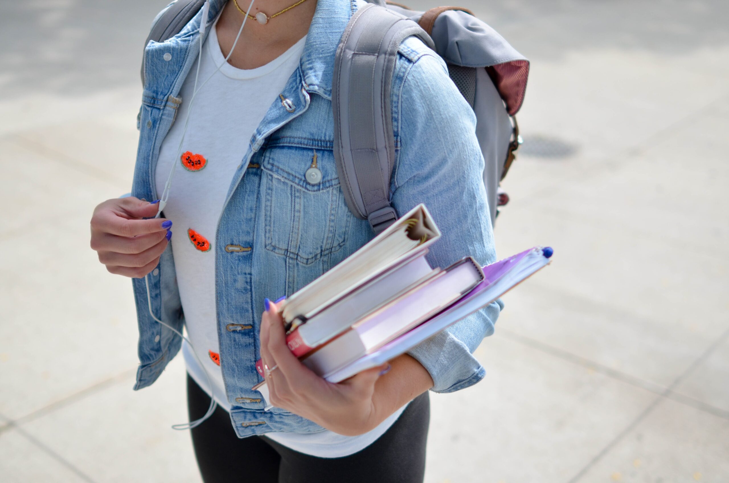 school child with backpack and holding school books