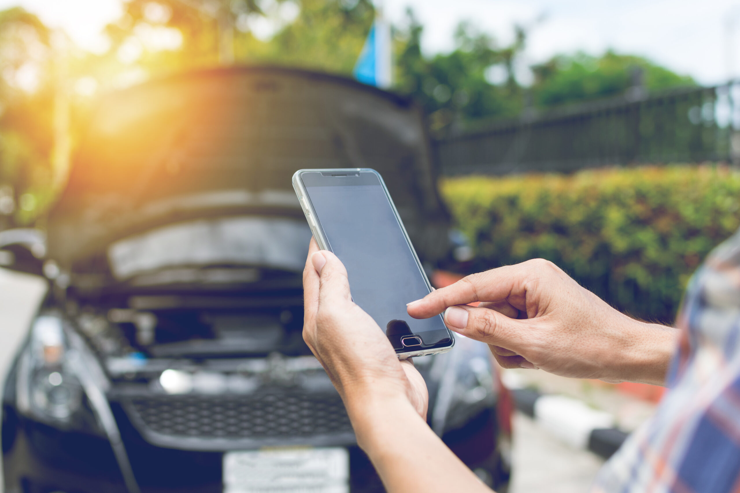 person on mobile phone looking for urgent cash loans for car repairs