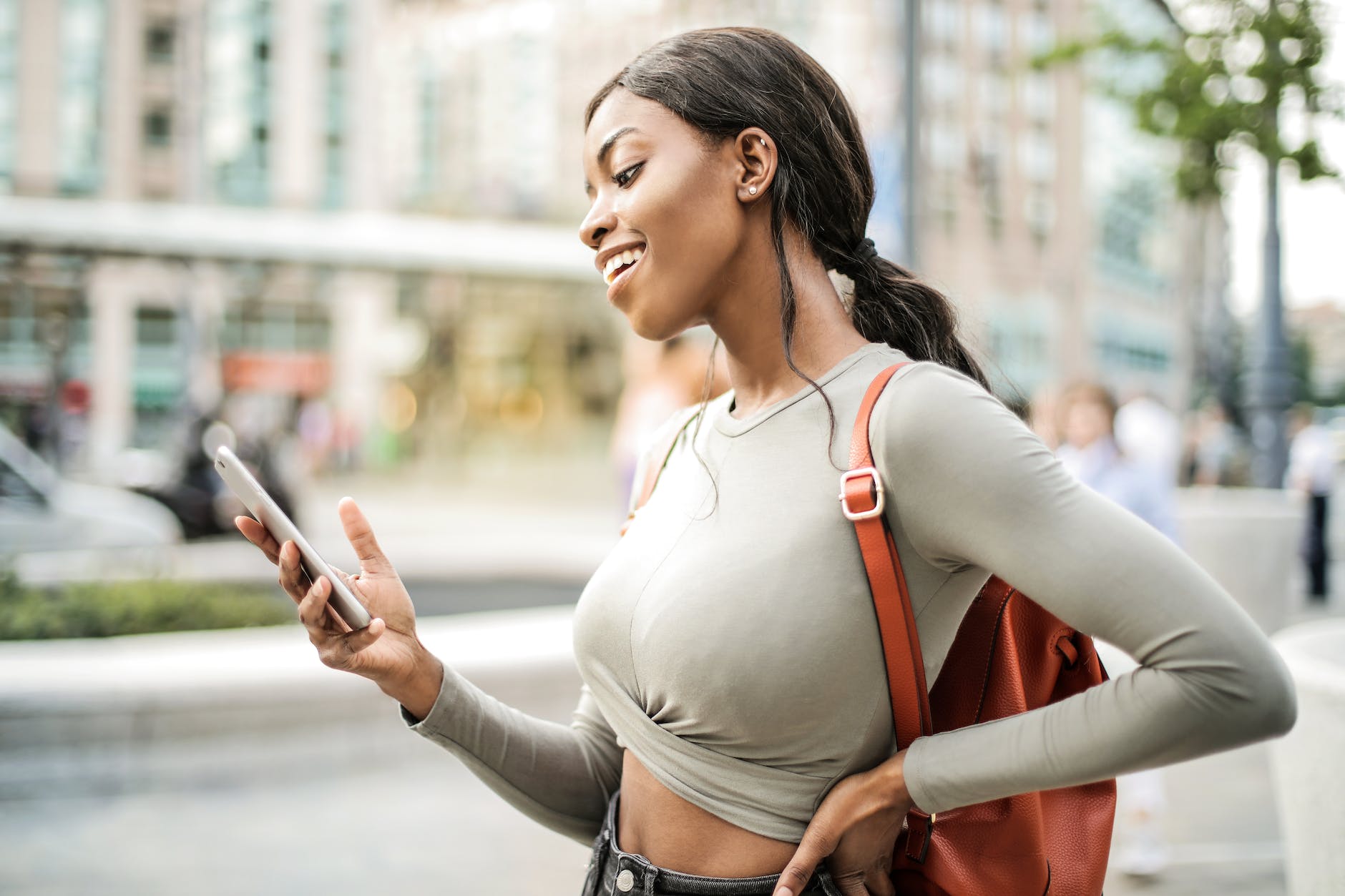 shallow focus photo of woman holding smartphone