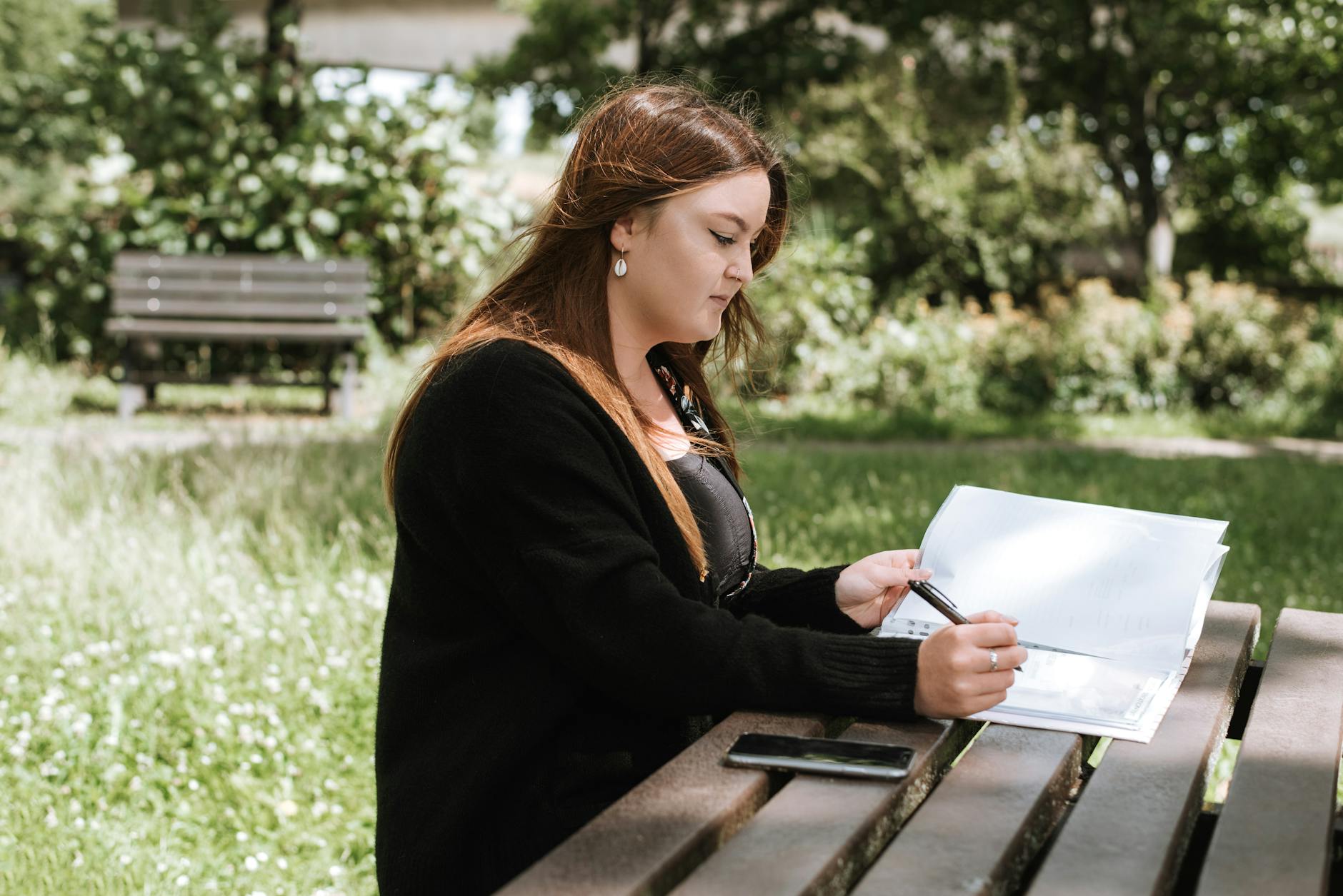 woman correcting credit mistakes on paper with pen