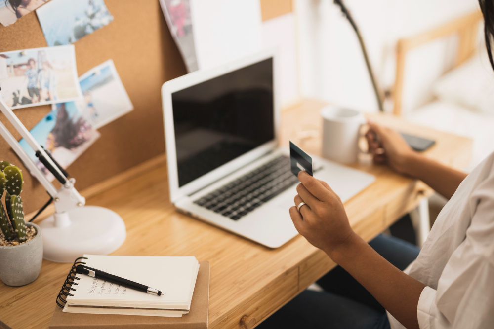 person using credit card on computer